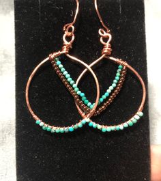 I love turquoise and I also love the warmth of copper. These lightweight (3.6 grams for the pair)  hoops feature itty bitty turquoise beads.  They hang just past two inches and dangle beautifully!  Handmade in a smoke free and pet free home. Artisan Small Hoop Copper Jewelry, Unique Handmade Turquoise Hoop Earrings, Turquoise Teardrop Jewelry For Crafting, Turquoise Wire Wrapped Copper Earrings, Turquoise Wire Wrapped Hoop Earrings Gift, Handmade Copper Turquoise Jewelry, Turquoise Copper Dangle Jewelry, Nickel-free Turquoise Jewelry For Crafting, Handmade Copper Jewelry In Turquoise