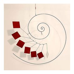 a drawing of a spiral with red squares on it