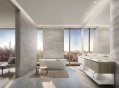 a bathroom with a tub, sink, and large window overlooking the cityscape