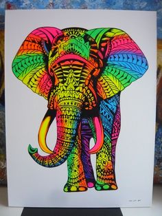 an elephant with colorful patterns on it's face