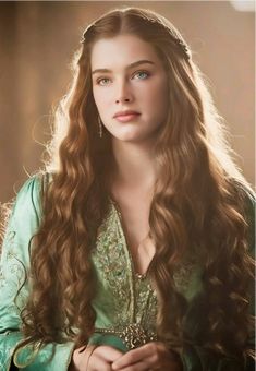 a woman with long hair wearing a green dress