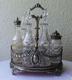 an ornate silver tray with glass bottles on it