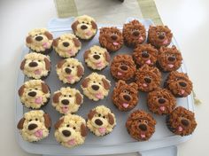 cupcakes made to look like dogs and puppies on a tray with other dog treats