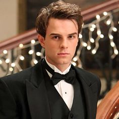 a young man in a tuxedo and bow tie