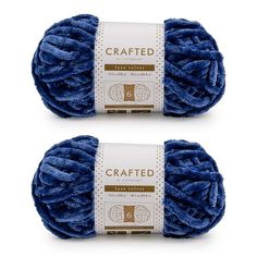 two balls of blue yarn with the words crafted written on them in gold and white