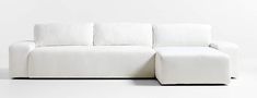 a white couch sitting on top of a white floor