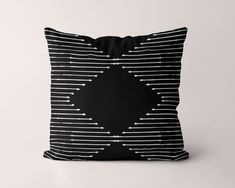 a black and white pillow with lines on it