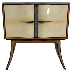 an art deco cabinet with two doors and drawers