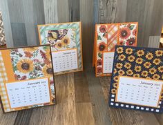 three small calendars with sunflower designs on them