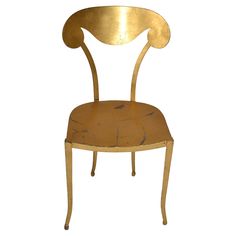 a gold colored chair with an oval back and seat, on a white background the chair is shaped like a bird's head