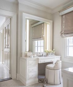 an elegant bathroom with white furniture and chandelier