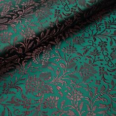 green and brown brocaded fabric with floral designs