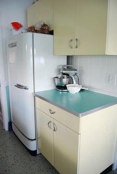 a white refrigerator freezer sitting inside of a kitchen