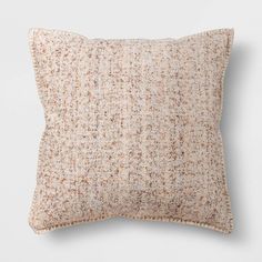 a white pillow with brown speckles on it