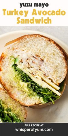 there is a turkey avocado sandwich on the plate