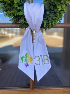 a wreath with the number eighty eight on it hangs from a window sill in front of a building