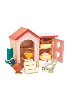 a wooden toy house with chickens and other toys