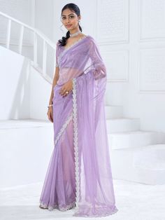 Our enchanting lavender swarovski work organza party wear saree is a stunning piece that exudes charm and elegance. Made from high-quality organza material, this saree is adorned with intricate Swarovski work all over and features a heavy handwork border that adds a touch of luxury to the design. The saree comes with a matching lavender organza blouse that is embellished with zircon work, completing the look with a touch of glamour.
The 5.50-meter saree and unstitched blouse material allow for c Lilac Saree Lavender, Lavender Colour Blouse Designs, Lavender Saree Look, Lavender Colour Saree, Lavender Sarees, Organza Saree Blouse Designs Latest, Graduation Saree, Cinderella Phenomenon, Organza Saree Blouse Designs