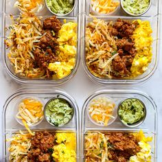 four plastic containers filled with different types of food and condiments on top of each other