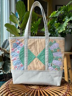 This one-of-a-kind tote showcases the artistry of a vintage quilt sourced from Carson City, Nevada. Each tote is a piece of heritage, lovingly remade to stand the test of time. Constructed from sturdy canvas, this tote will be your faithful companion for years to come, whether you're strolling through the local farmer's market or running errands in town. Embrace the spirit of this unique piece of functional and fashionable art, a testament to craftsmanship and history combined into a single, stylish accessory.  Features include:  * Fully lined with 15 oz. natural canvas  * Reinforced bottom  * Internal divided pocket * Approximately 15"w x 13"h x 5"d   Discover the perfect companion to this one-of-a-kind tote with an organizer bag, ensuring both style and functionality.  Explore organizers Vintage Beige Upcycled Bags, Vintage Cotton Shoulder Bag, Vintage Quilted Everyday Bag, Vintage Quilted Shoulder Bag For Everyday, Vintage Everyday Quilted Shoulder Bag, Vintage Quilted Shoulder Bag, Vintage Patchwork Bags For Everyday Use, Vintage Upcycled Tote Bag, Carson City Nevada