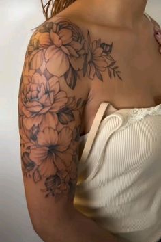 a woman's shoulder with flowers on it, and the back of her arm