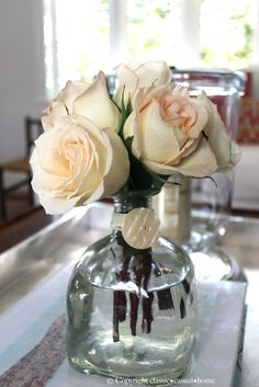 some white roses are in a glass vase