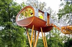 a tree house built on stilts in the woods