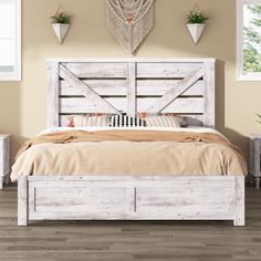 a white bed with wooden headboard and foot board