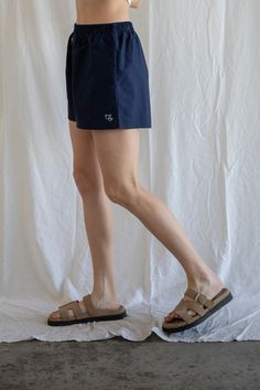 Our cotton boxer shorts with embroidered details, pockets, and an elastic waistband. - Sizing: Model is 5'8", wearing a size S - Content: 100% Cotton Care: Handwash recommended Imported Cotton Beachwear Bottoms With Built-in Shorts, Beachwear Bottoms With Built-in Shorts, Comfortable Cotton Shorts For Daywear, Cotton Athletic Shorts For Beach With Short Legs, Beachwear Cotton Athletic Shorts With Elastic Waistband, Cotton Athletic Shorts With Elastic Waistband For Beachwear, Cotton Beachwear Bottoms Short Length, Short Length Cotton Beachwear Bottoms, Vacation High-waisted Cotton Athletic Shorts