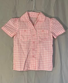 This Vintage 1970's girls shirt is a size 5T.  It is pink and white check with gathered short sleeves and a pocket on the front.  It is an item we rescued from an old abandoned store that was on property that we recently purchased in rural Tennessee.  This item is in great condition.  It is button down.  The chest width is 24 inches and the material is a cotton blend. The shoulder seam to hem is 16 inches. To see more of our vintage 1970's inventory please visit our store at ChoiceRecycling.  If Abandoned Store, Pink Flannel, Girls Shirt, Girls Blouse, Girly Fashion, Button Down Blouse, Pink Blouse, Vintage 1970s, Pink And White