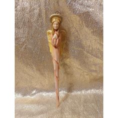 an angel figurine on a gold background