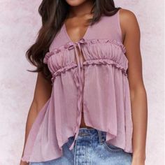 This Mauve Purple Top Brings A Touch Of Elegance With Its Ruffle And Frill Details. The V-Neckline And Asymmetrical Hem Create A Stylish, Dynamic Look, While The Sleeveless Design Adds A Modern Flair. Crafted From Semi-Sheer Chiffon, This Loose-Fit Top Offers A Regular Length And A Lightweight Feel, Perfect For Layering Or Wearing Alone. The Unlined Body Enhances Its Delicate, Airy Quality, Making It An Ideal Choice For Both Casual And Dressy Occasions. Flirty V-neck Tank Top For Summer, Flirty V-neck Summer Blouse, Summer Blouse With V-neck And Vest Detail, Flirty Sleeveless Spring Blouse, Summer V-neck Camisole For Parties, Flirty Sleeveless Blouse For Spring, Flirty Sleeveless Camisole For The Beach, Mauve Purple, Loose Fitting Tops