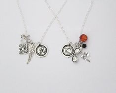 Are you a fan of the ineffable Aziraphale and Crowley? This is the perfect necklace set for any Good Omens fan. Featuring iconic charms for both Crowley and Aziraphale, as well as your choice of initial charms, partners in crime, or best friends!- Your choice of necklace! You can pick just your favorite character or buy them as a pair!- Choose from letter initials, "Partners in Crime", or "Best Friends" heart charms.- Your choice of size for Crowley sunglasses. Choose from Large or Small.------- Good Omens Earrings, Fandom Style Personalized Jewelry Gift, Personalized Fandom Jewelry Gift, Personalized Themed Sterling Silver Necklace, Themed Silver Necklace For Birthday, Crowley Sunglasses, Crowley Good Omens, Crowley And Aziraphale, Aziraphale And Crowley