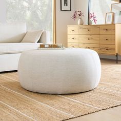 a living room with a large white ottoman