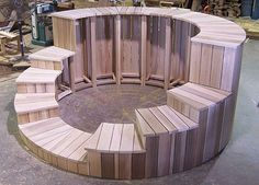 a circular bench made out of wooden boards