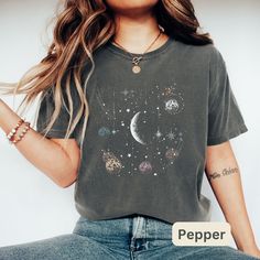 Celestial Moon and Stars Design Woman's Soft and Comfortable T Shirt. These shirts are so comfy you'll never want to take them off. Buy several, so you can have one for every day of the week. ►SHIRT DETAILS: The garment-dyed t-shirt by Comfort Colors is a customizable tee made entirely from ring-spun cotton. Its soft-washed, garment-dyed fabric adds an extra layer of comfort to your wardrobe, while the relaxed fit makes it a versatile daily option. The shirt's double-needle stitching ensures high durability, and its tubular shape is retained by the absence of side-seams. Choose the Comfort Colors garment-dyed t-shirt for a soft, durable and customizable addition to your wardrobe. ►SIZING: * See Size Chart in Listing Photos * Unisex sizing * To make sure to get the right fit, take your favo Celestial Short Sleeve Tops With Moon Print, Trendy Relaxed Fit Top With Moon Print, Celestial Crew Neck Top Relaxed Fit, Celestial Crew Neck Top With Relaxed Fit, Celestial Relaxed Fit Crew Neck Top, Moon Phase Astrology, Vintage Graphic T Shirt, Stars Vintage, Moons And Stars