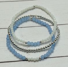 Momentum Bracelets Beautiful Beaded Bracelet Handmade with 4mm Icy Blue Glass Beads, 3mm Cloudy White Glass & 3mm Sterling Silver Beads Strung on High Performance Elastic. Buy Individual Bracelet or All Three as a Stack. Reference picture with name of bracelet next to image for bracelet name. Cloudy White Beaded Bracelet Sterling Silver Beading Bracelet Icy Blue Beaded Bracelet Select your Bracelet Size Handle Bracelets with Care: Roll bracelets on to avoid overstretching. Avoid perfumes, lotion Blue Stackable Beaded Bracelets As Gift, Blue Stackable Bracelets For Summer, Blue Stacked Bracelets Gift, Blue Stacked Beaded Bracelets, Hand-strung Light Blue Beaded Bracelets, Beautiful Beaded Bracelet, Sterling Silver Bead Bracelet, Blue Beaded Bracelets, Trendy Bracelets