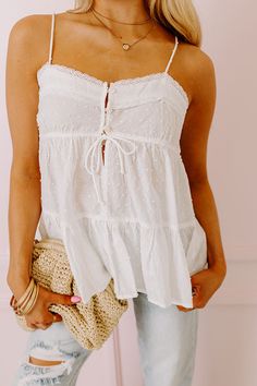 - Perfect for a sunny day, this adorable top pairs perfectly with a sun-kissed glow! - Unlined dot textured material with lace trimmed accents - A v-cut neckline with a 3 buttoned front - Thin, adjustable spaghetti straps - A functional drawstring under the bust - A flowy silhouette that ends in a ruffled hemline Babydoll Tops, Babydoll Tank Top, Babydoll Tank, Dot Texture, Summer 24, Senior Pics, Babydoll Top, V Cut, V Cuts