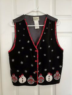 a black sweater vest with snowmen on it