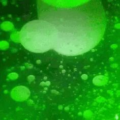 green bubbles are floating in the water