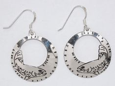 Our solid Sterling silver earrings are etched with swimming salmon/trout. Sterling silver ear wires. Semaki & Bird exclusive design. One inch diameter hoops. Good luck for the fly fisher persons in your life! Proudly made in U.S.A. Personalized Silver Dangle Hoop Earrings, Silver Adjustable Fish Hook Earrings, Personalized Round Silver Earrings, Personalized Sterling Silver Hoop Earrings, Personalized Small Hoop Silver Jewelry, Adjustable Sterling Silver Fish Hook Jewelry, Catch And Release, Hoop Earrings Silver, The Fly