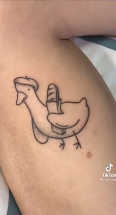 a tattoo on the side of a woman's thigh with a bird flying over it