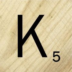 the letter k is made up of wood and has black letters on it's side