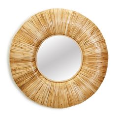 a round mirror that is made out of bamboo