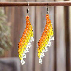 Aretes de Chaquira - TM-0818-05 Beaded Earrings. Aretes de chaquira con colores, llamativos, elegantes y tradicionales, diferentes formas, que lucen increibles con ropa casual y elegante.Fabricados por manos artesanales, hechos en Mexico. Beaded earrings with colors, striking, elegant and traditional, different shapes, which look incredible with casual and elegant clothes.Made by Mexican artisans. Medida de largo: 3 pulgadas aproximadamente / Length measurement: 3 inches approximately. Nantli's Elegant Clothes, Length Measurement, Different Shapes, Orange Yellow, Beaded Earrings, Yellow White, Orange, Yellow, For Sale