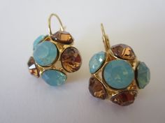 Amazing gold plated earrings placed with Swarovski Pacific Opal and Light Smoked Topaz Chaton rhinestone.  These stunning earrings will be the perfect completion for a glow and unforgettable look!