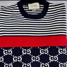 Gucci Gg Supreme Striped Knit Sweater. Gucci Sweater Is Crafted In Cotton With Jacquard Gg And Stripes. This Sweater Features A Ribbed Crew Neck, Long Sleeves, Red Tape Detail, And A Ribbed Hem And Cuffs. - Black Embroidered Sweater With Red And White Stripe - 100% Wool - Pull-Over Style, Long Sleeve Sweater - Embroidered Gg Pattern - Ribbed Detailing On The Collar, Bottom, Sleeves - Size M, L, Xl - Product Number 496458 - Made In Italy Luxury Gucci Jacquard Knit Sweater, Gucci Designer Winter Sweater, Gucci Luxury Tops For Winter, Luxury Gucci Tops For Winter, Luxury Gucci Winter Top, Gucci Sweater, Striped Knit Sweater, Red Tape, Embroidered Sweater