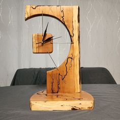 a clock made out of wood sitting on top of a table