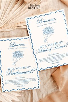 the wedding stationery is laid out on top of some fanned paper, which reads will you be my bridesmaid?