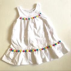 Baby Guess Infant Girls Birthday Dress 18 Months Solid White Colorful Pom Poms Item Details: 100% Cotton Machine Wash Cold Button Opening At The Back Tiered Skirt Imported Approximate Measurements Laid Flat: Armpit To Armpit: 11" Top Of Shoulder To Hem: 17.5" White Sleeveless First Birthday Dress, White Sleeveless Dress For First Birthday, Cute White Dresses For Playwear, White Cotton Dress For Playtime, White Cotton Dresses For Playtime, Playful White Cotton Dress, White Cotton Dress For Birthday, Cotton Sleeveless Dress For First Birthday, Playful White Playwear Dress